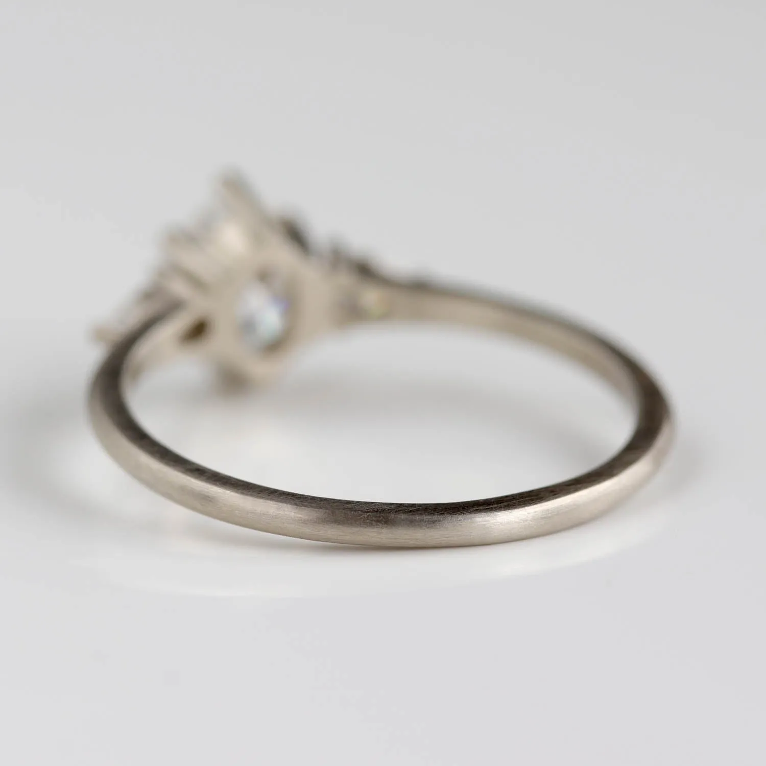 Prong-set Oval Three Stone Ring with Pear-shaped Side Stones •